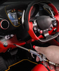 Hand using 13-Piece 2-Way Air Nozzle Kit with Quick Connects inside red car interior for efficient cleaning.