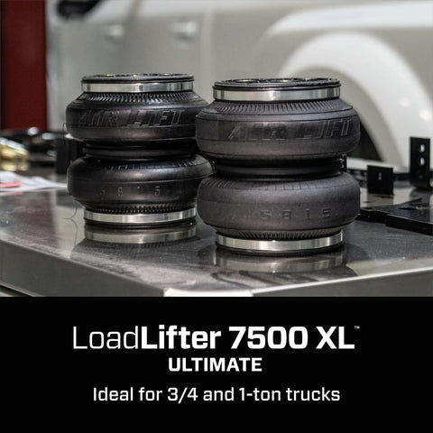 Premium air spring kit delivers up to 7500 lbs leveling, adjustable 5 to 100 psi, shown on display table for trucks.