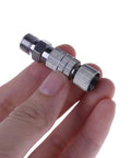 Person holding Fast Swap Quick Release Airbrush Coupler Kit With One Eighth Inch BSP Male And Female Adapters in hand.