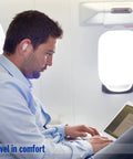 Man wearing Pillow Soft Moldable Silicone Ear Plugs For Sleeping And Travel on airplane, focusing on laptop