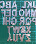 26 Capital Alphabet Dies Set For Metal Cutting, Card Making, Scrapbooking And DIY Embossing Projects on green grid