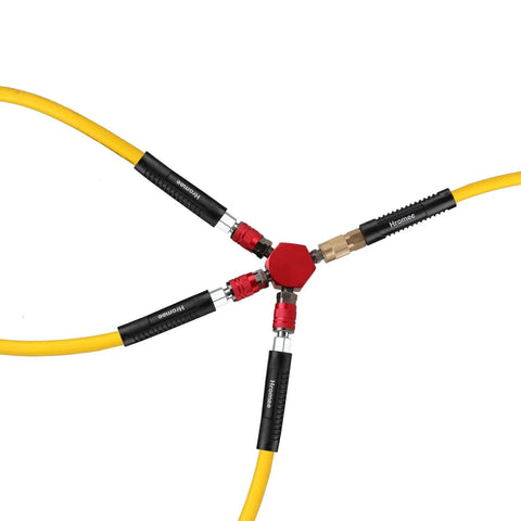 3-Way Air Manifold With Four Ports Aluminum Flat Hex Quick Connect Air Hose Splitter with yellow hoses attached in workshop setting