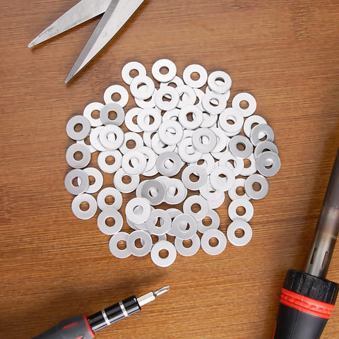 Aluminum Back Up Rivet Washers For 1/4 Inch POP Rivets 310 Pieces on wooden surface with tools around