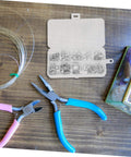 Aluminum Crush Washer Set With 200 Pieces Heat Resistant Oil Drain Plug Gaskets in storage box, tools on a wooden surface