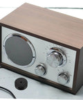 Wooden tabletop radio with aluminum foot pads for electronics isolation feet for turntables computers speakers and subwoofers.