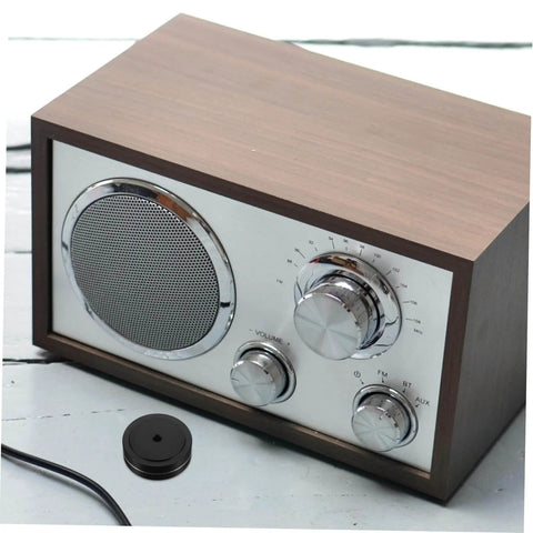 Wooden tabletop radio with aluminum foot pads for electronics isolation feet for turntables computers speakers and subwoofers.
