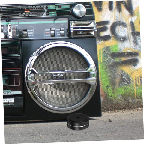 Aluminum Foot Pads For Electronics Isolation Feet For Turntables Computers Speakers And Subwoofers No Slip Anti Vibration Bumpers next to a boombox