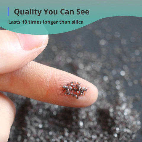 Close-up of Efficient #80 aluminum oxide blast media on fingertip showing texture and size, suitable for rust removal and surface prep.