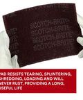 Gloved hands holding General Purpose Very Fine Grade Hand Pad 6 by 9 Aluminum Oxide Pack of 20 Maroon
