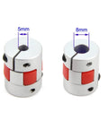 Aluminum Plum Shaped Flexible Shaft Coupling 5mm To 8mm Bore D20xL25 For Servo And Stepper Motors, two pieces with red inserts.