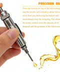 Car Precision Oiler Portable Aluminum Lube System Oiling Pen With Pocket Clip and Screw On Cover, shown dispensing oil.
