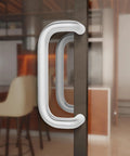 Offset Back To Back Aluminum Pull Handles with clear anodized finish on modern glass door.