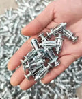 Hand holding 8Pcs Jack Nuts And Petal Screw Anchors Expansion Plugs For Board And Wall Fasteners Set M5x25mm Type 03