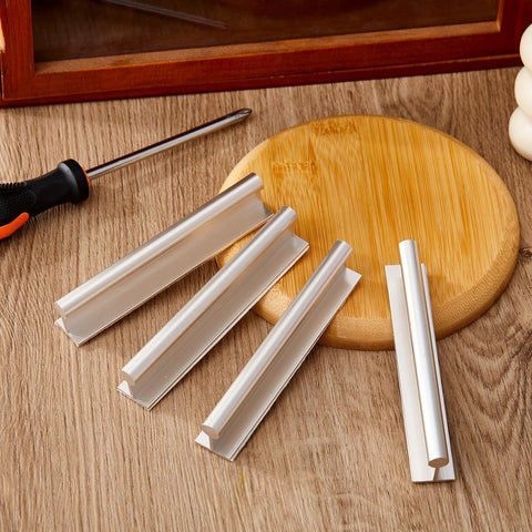 Four Pcs SelfAdhesive Edge Finger Pull Door Handles For Cabinets Closets And Sliding Doors on a wooden surface