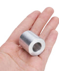 Person holding a piece from an Aluminum Spacer Set Four Pieces Half Inch Bore One Inch Outer Diameter One Inch Length Round Standoffs.