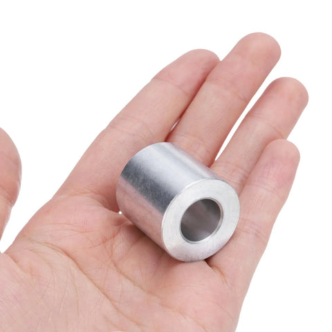 Person holding a piece from an Aluminum Spacer Set Four Pieces Half Inch Bore One Inch Outer Diameter One Inch Length Round Standoffs.