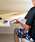 Man using Precision Aluminum Round Bullseye Spirit Level Tool, 74mm Diameter on a wooden surface in a workshop