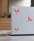 Set Of 3 Angel With Machine Gun Stickers on a laptop, 3 inch vinyl decals for personalizing water bottles, laptops, phones, cars, helmets, windows.