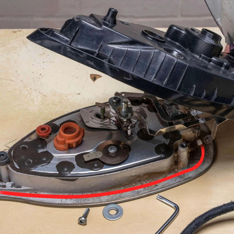 Close-up view of an automotive engine part with visible hose and seal components