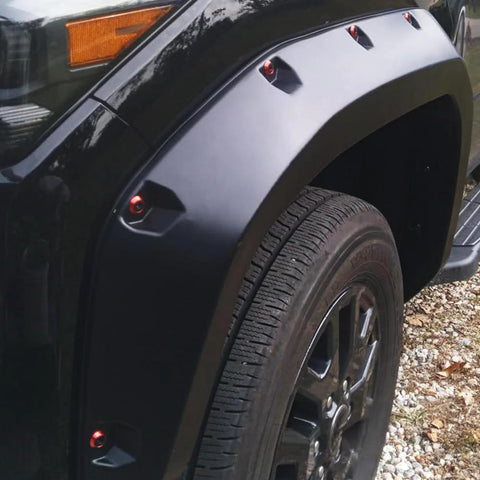 Widebody flare installed with 24 Piece M6 18mm Anodized Aluminum Tapered Washer Kit on a vehicle's front wheel arch