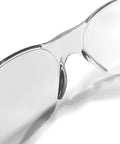Close-up of ANSI Z87 safety glasses with impact-resistant lenses and UV protection in clear frame, part of 12-pack