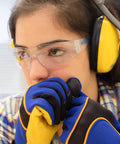 Person wearing ANSI Z87 Safety Glasses with Impact-Resistant Lenses and UV Protection, earmuffs and gloves indoors