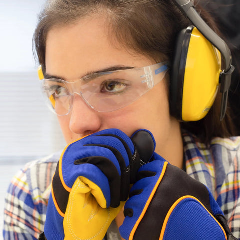Person wearing ANSI Z87 Safety Glasses with Impact-Resistant Lenses and UV Protection, earmuffs and gloves indoors