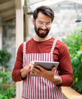 Man wearing ANSI Z87 Safety Glasses With Impact-Resistant Lenses And UV Protection holding a tablet in a greenhouse