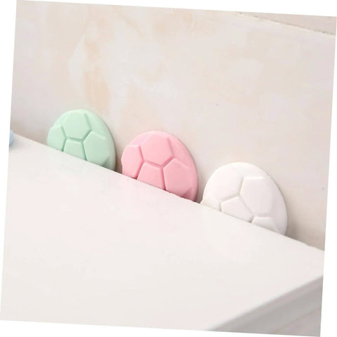 Side view of assorted green, pink, and white protective pads for washing machine and home use anti collision door handle bumpers