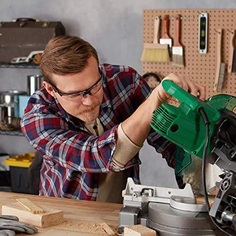 Person wearing Anti Fog Safety Goggles For Shooting With Clear Lens using a green power tool in workshop