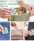 Person placing Large Anti-Fog Lens Wipes 12x12cm, 100 Count, Individually Wrapped for Glasses in pockets and a bag.