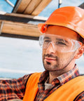 Worker wearing Anti Fog Safety Glasses Wide Eye Shield ANSI Z87.1 EN 166 UV Protected 2 Pack on construction site