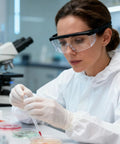Lab technician wearing Anti Fog Safety Glasses With Clear Wraparound Lenses for Lab Work And DIY Projects, conducting experiment.
