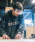 Man wearing Two Pack Anti Fog Safety Goggles With Adjustable Fit And Lightweight Lenses while working in a woodshop.
