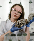 Scientist wearing Anti Fog Safety Goggles 2 Pack With Adjustable Temples And Clear Lens ANSI Z87.1 in laboratory.