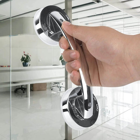 Hand holding Anti Slip Vacuum Suction Cup Handrail for bathroom and kitchen on glass door, chrome ABS PC grab bar handle, no sweat install.