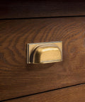 Close-up of antique brass cabinet cup pull on wooden drawer, part of 10 Pack Antique Brass Cabinet Cup Pulls 5 Inch 128mm Durable Zinc Alloy.