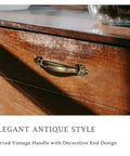 4 Pack Antique Brass Cabinet Handles With Vintage Decorative Drawer Pulls on wooden dresser, close-up view
