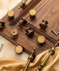 10 Pack Vintage Antique Brass Cabinet Knobs 1 Inch Round Dresser Knobs For Kitchen Cabinets Drawers And Furniture Brushed Brass Finish Single Hole Cupboard Door Knob Durable Solid Brass Hardware displayed with screws on wooden surface.