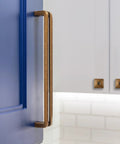 Antique Brass 5 Inch Hole Center Heavy Duty Solid Cabinet Pull on a blue kitchen cupboard, showcasing vintage style and zinc alloy durability