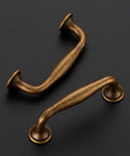 Two antique brass cabinet pulls from the 20 Pack 3 Inch Antique Brass Cabinet Pulls Set for Kitchen Cabinets and Drawers Solid Zinc Alloy Cupboard Hardware.