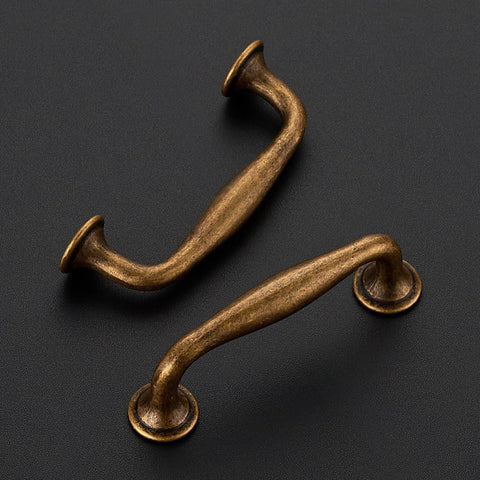 Two antique brass cabinet pulls from the 20 Pack 3 Inch Antique Brass Cabinet Pulls Set for Kitchen Cabinets and Drawers Solid Zinc Alloy Cupboard Hardware.
