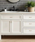 White bathroom vanity with Antique Brass Cabinet Pulls 3 Inch Center 10 Pack Zinc Alloy Handles, vintage style hardware installed on drawers.