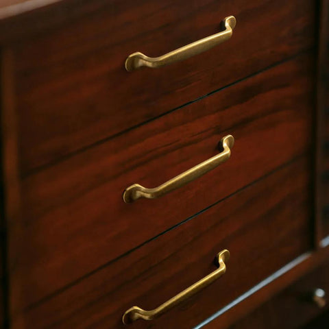 Set Of Six Traditional Five Inch Center To Center Antique Brass Cabinet Pulls With Curved Classic Design For Vintage Inspired Kitchens And Cabinets Durable Sturdy Metal Hardware For Drawers And Doors Easy To Install on wooden drawers