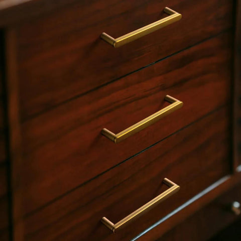 Antique Brass Cabinet Pulls Set Of 6, 5 Inch Center To Center, Minimalist Vintage Drawer Handles installed on wooden drawers.