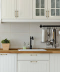10 Pack Antique Brass Cabinet Pulls 5 Inch Drawer Handles For Kitchen Cabinets installed on white drawers and doors