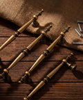 Antique Brass Cabinet Pulls Set Of 6, 7.32 Inch Long With 5.04 Inch Center-To-Center on burlap fabric and wooden surface