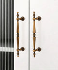 Antique Brass Cabinet Pulls Set Of 6, 7.32 Inch Long With 5.04 Inch Center-To-Center installed on white cabinet doors