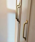 Set Of Six Traditional Five Inch Center To Center Antique Brass Cabinet Pulls With Curved Classic Design For Vintage Inspired Kitchens
