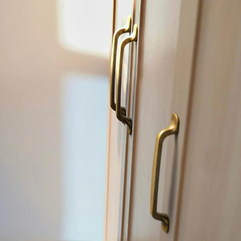 Set Of Six Traditional Five Inch Center To Center Antique Brass Cabinet Pulls With Curved Classic Design For Vintage Inspired Kitchens